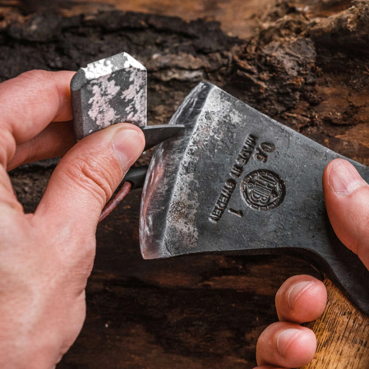 Wazoo Viking Spark Necklace being used to sharpen an axe